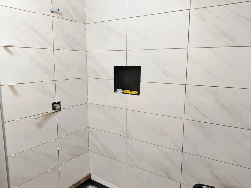 Shower wall grout joint size even silicone corners