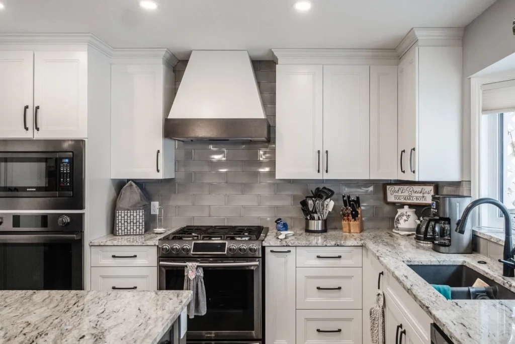 White cabinets granite countertop gray white subtle backsplash