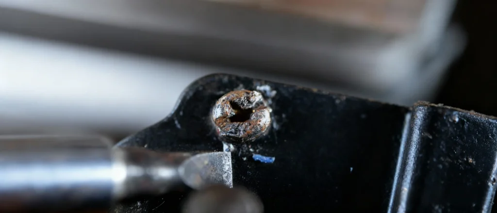 Remove stripped screw from metal