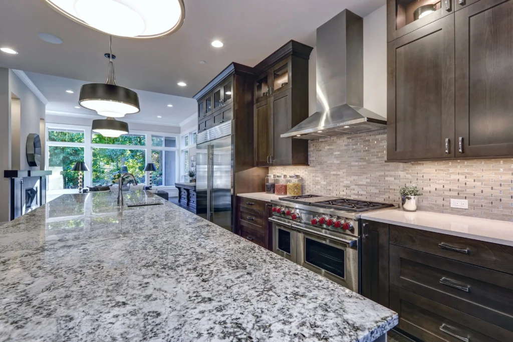 Kitchen with coordinated stone countertop cabinets and backsplash