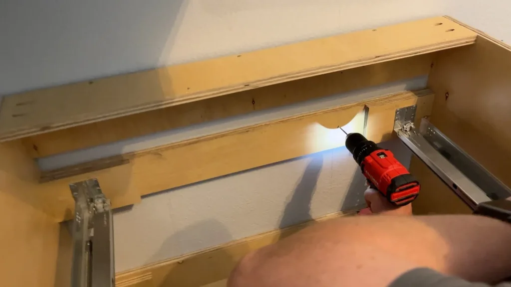 Cabinet screw back rail into stud pilot hole countersink safety glasses