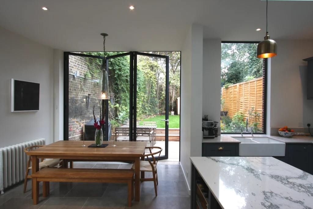 Open plan living room where Folding Doors align with kitchen and terrace finishes